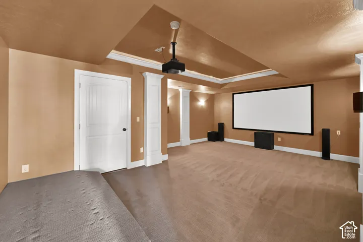 Recessed tray ceiling, wall-mounted projection screen, tiered flooring platform, and custom architectural columns