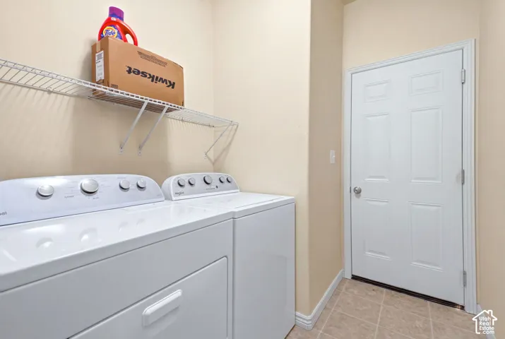 Laundry room with white wire shelving and garage access.
