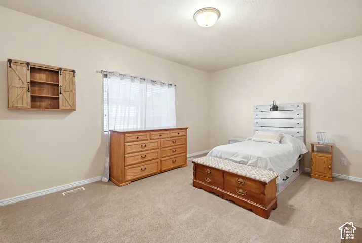 Primary bedroom with attached full bath and walk in closet