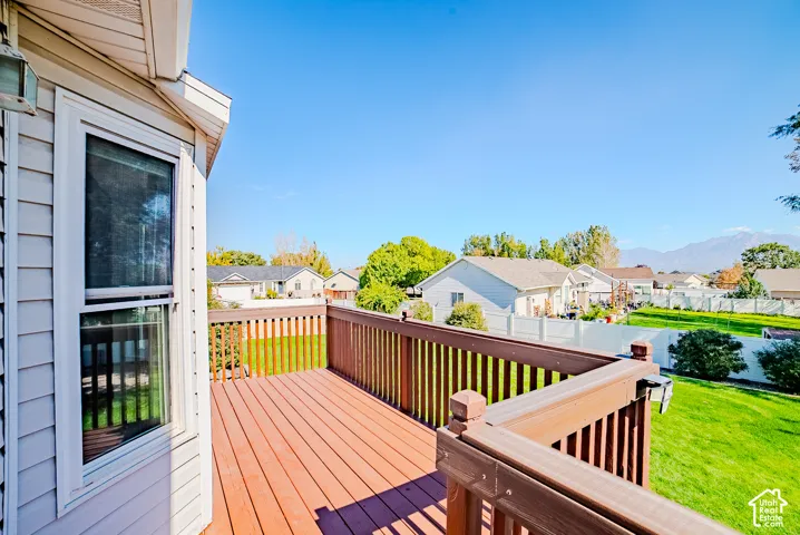Raised deck featuring wood-finish decking, composite railing, and mountain backdrop