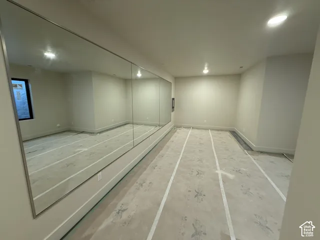 Wall-to-wall mirror installation, recessed ceiling lighting, and neutral wall tones