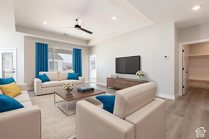 Living area featuring a coffered ceiling, recessed lighting, ceiling fan, and wood-finish flooring