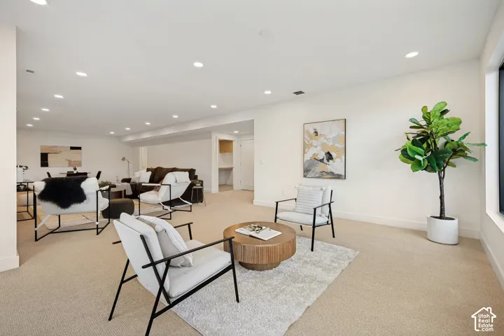 Open-concept interior featuring neutral wall tones, recessed lighting, and wall-to-wall carpeting