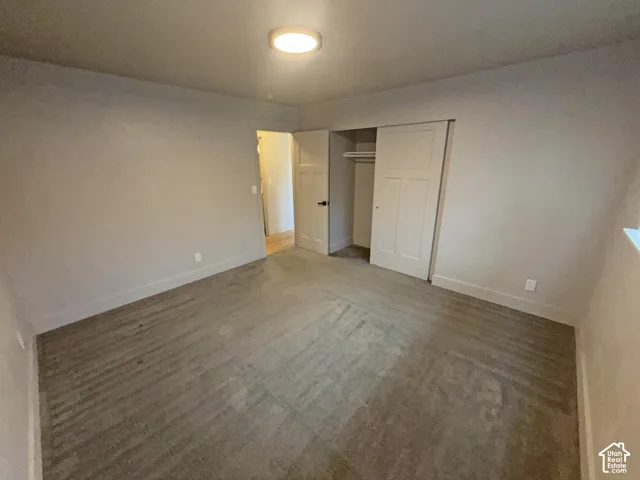 Recessed ceiling light fixture, neutral wall finishes, sliding closet doors, and carpet flooring