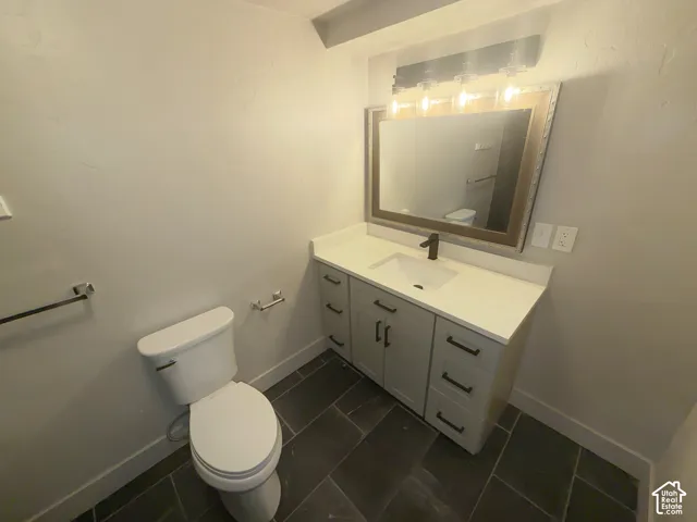 Vanity with an integrated sink, black hardware, and a white countertop