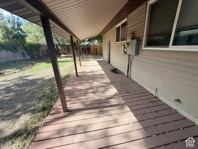 Covered patio with wood-finish decking and vinyl siding