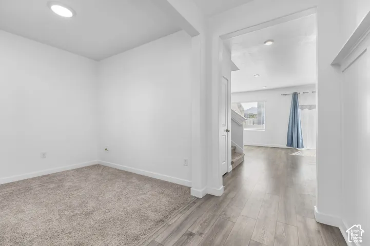 Neutral interior featuring recessed lighting, wood-finish flooring, and wall-to-wall carpeting