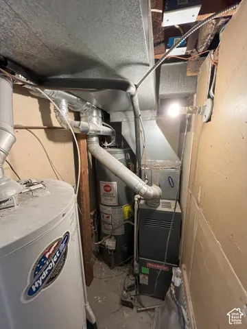 Mechanical utility area featuring two water heaters, a high-efficiency furnace, and galvanized ductwork