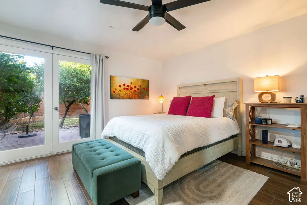 Wood-look flooring, ceiling fan, and white walls