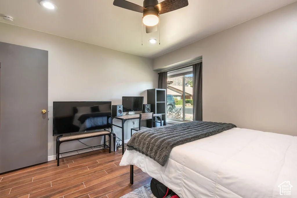 Wood-finish flooring, recessed lighting, and a ceiling fan with integrated lighting