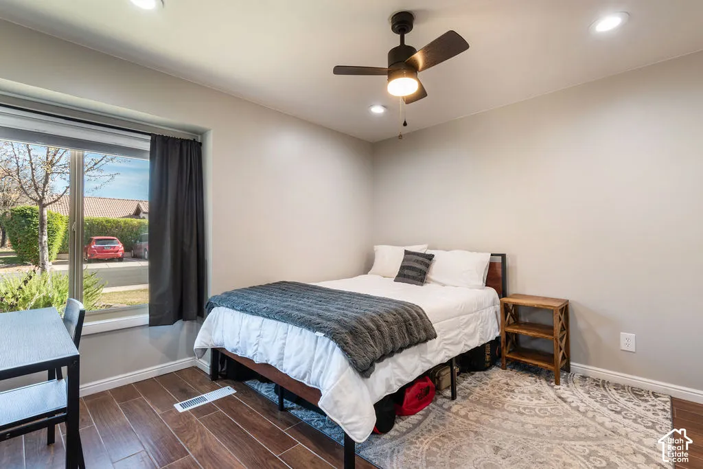 Recessed lighting, ceiling fan with integrated lighting, wood-finish flooring, and a large window