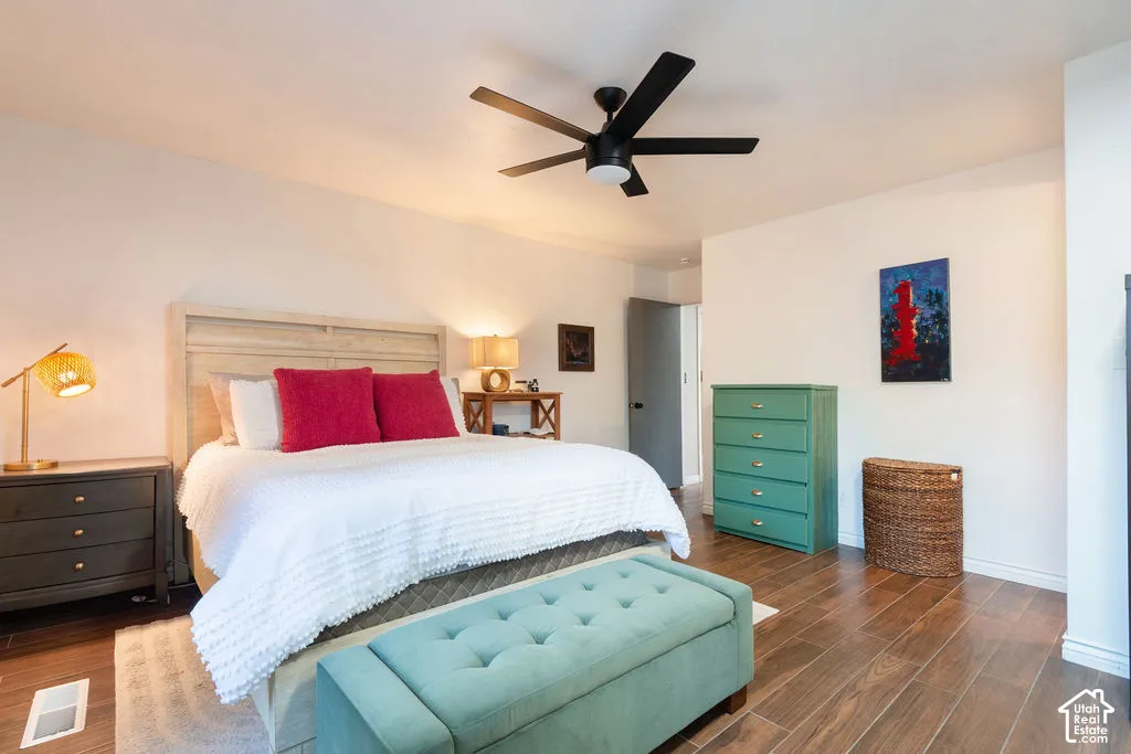 Wood-finish flooring, recessed lighting, and a black ceiling fan with integrated lighting