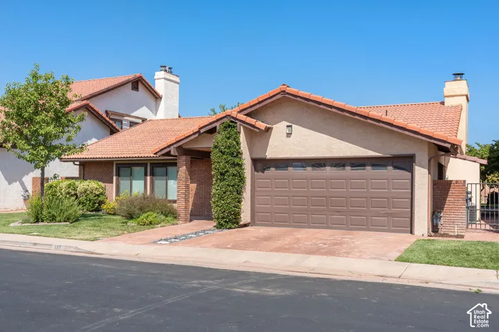 Stucco exterior with brick accents and a tile roof