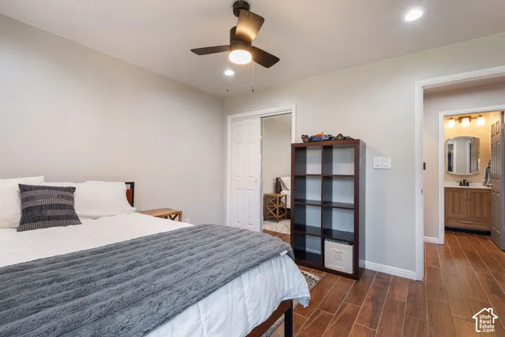 Recessed lighting, ceiling fan, wood-finish flooring, light-toned walls, and a built-in closet with sliding doors