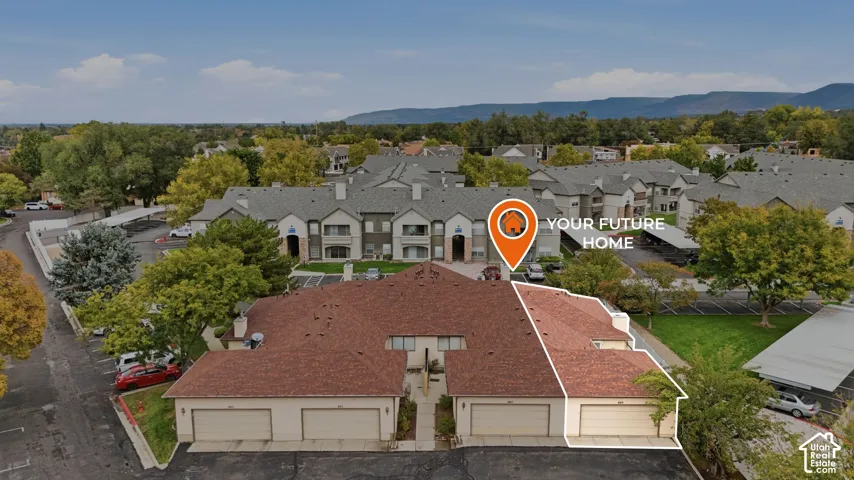 Multi-unit complex featuring an asphalt shingle roof, attached garages, and paved surface parking