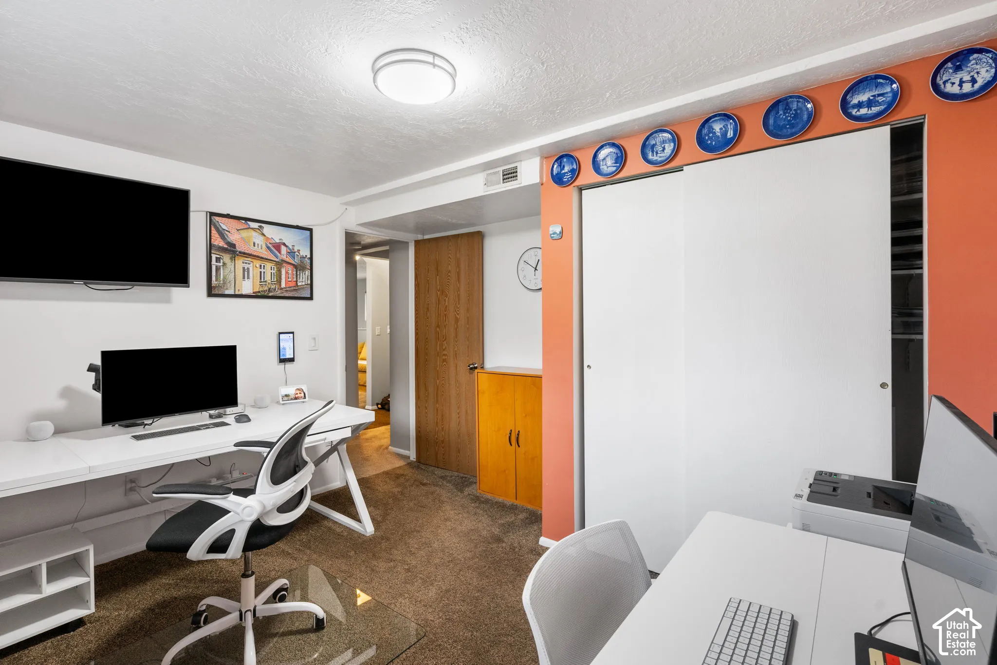Built-in wall-mounted desk, dual sliding-door closet, wood-finish interior door, and flush-mount overhead lighting