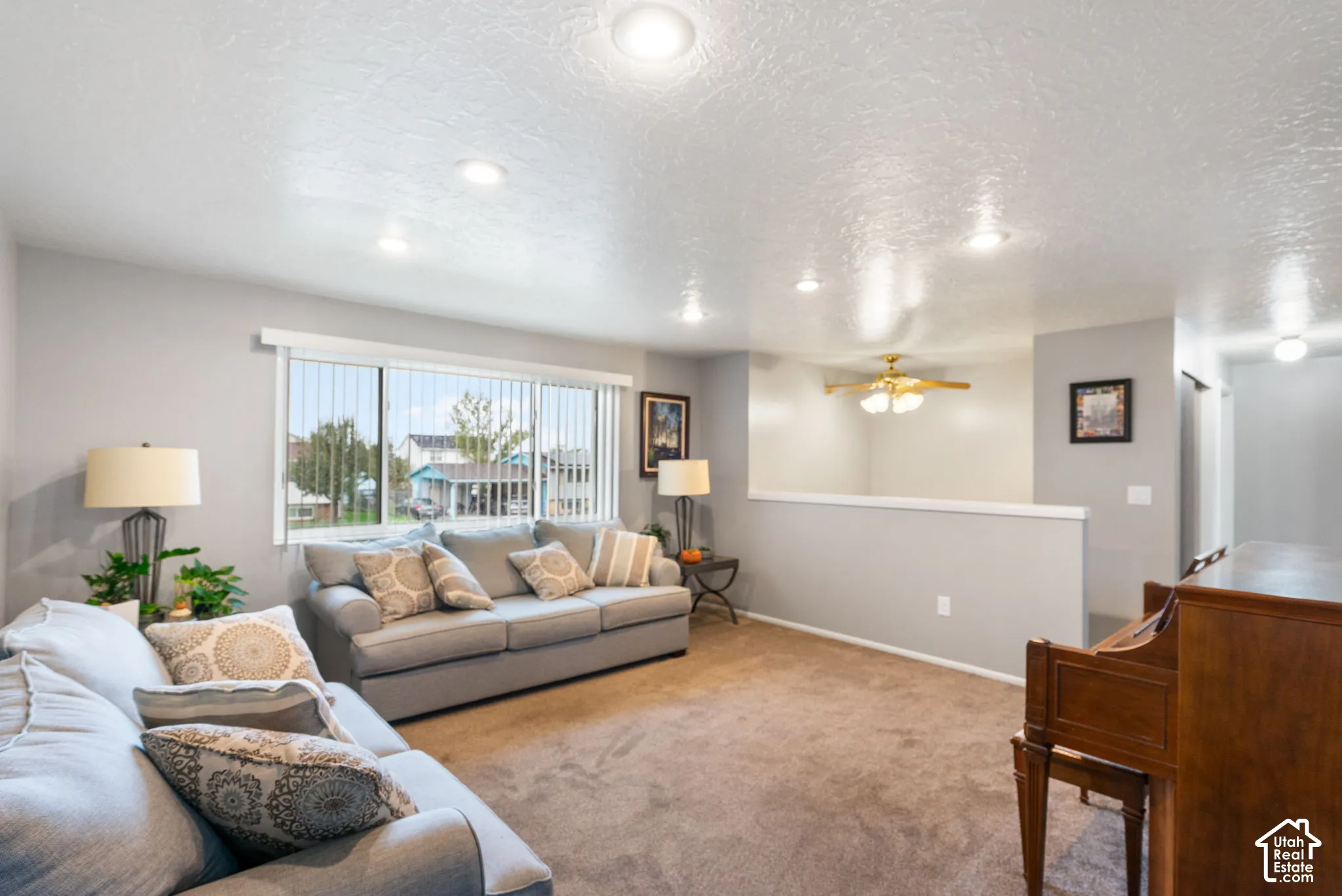 Interior space featuring recessed lighting, a ceiling fan with integrated light fixture, horizontal sliding windows, and neutral carpeting