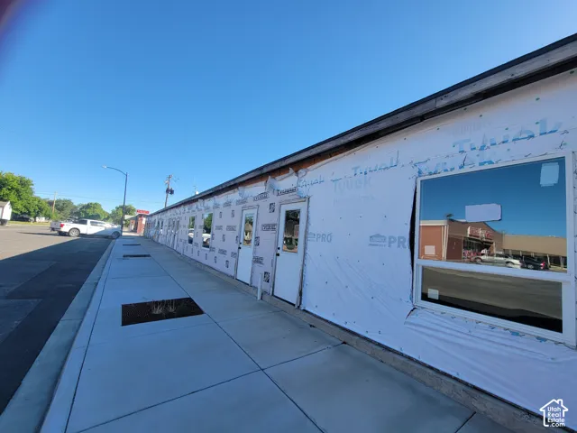 Side angle with view of sidewalk and parking stalls.