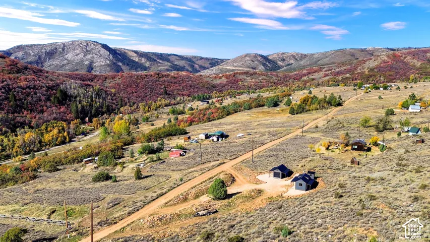 Expansive landscape featuring distant mountains and a dirt road network