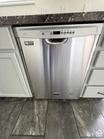 NEW Stainless steel built-in dishwasher featuring a digital control panel, stone-finish countertop, Shaker-style cabinetry, and tile flooring