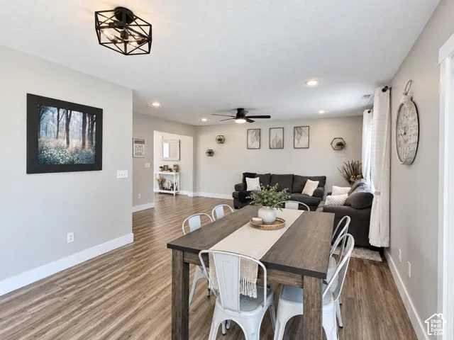 Open floor plan featuring wood-finish flooring, recessed lighting, and a geometric-frame ceiling fixture