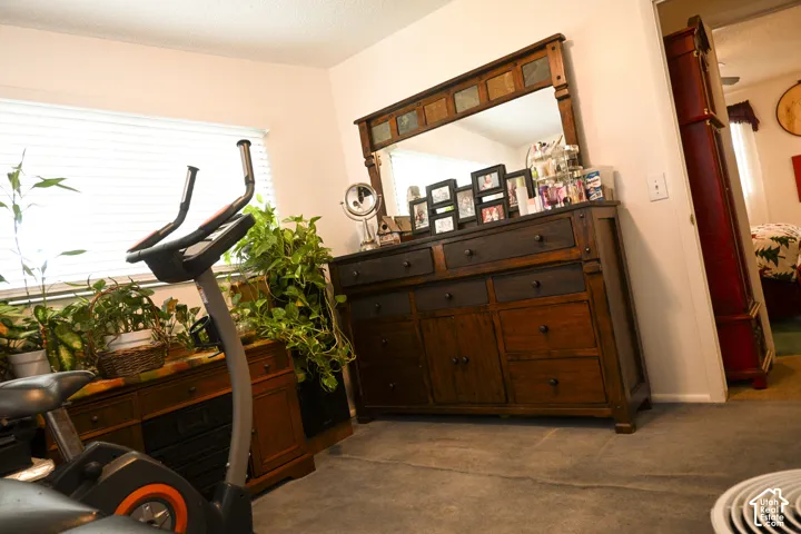 Room featuring carpeting and horizontal blinds covering a window