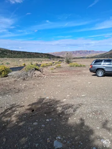 Expansive natural lot featuring desert terrain, native shrubs, and mountain horizons