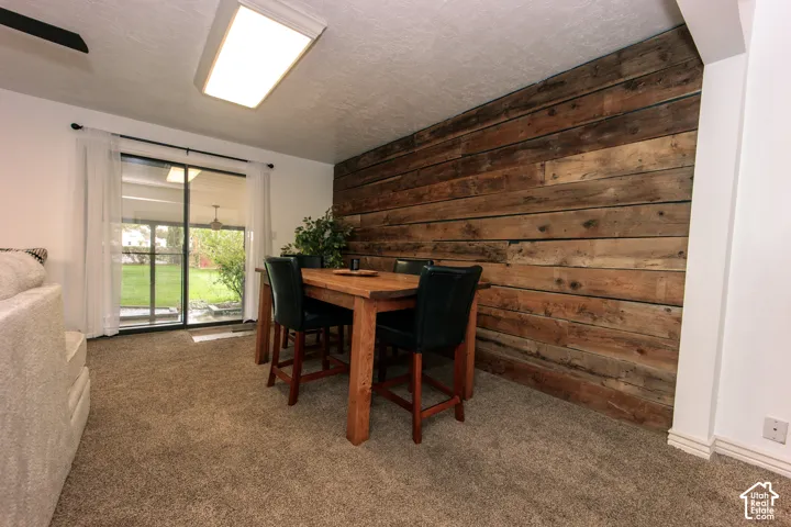 Interior space featuring a horizontal wood-plank accent wall and sliding glass door with external access