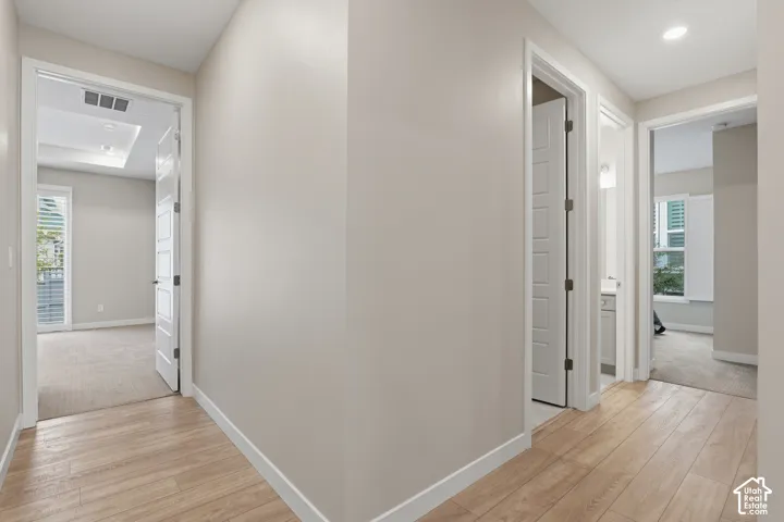 Neutral-toned interior featuring wood-finish flooring, recessed lighting, and white five-panel doors