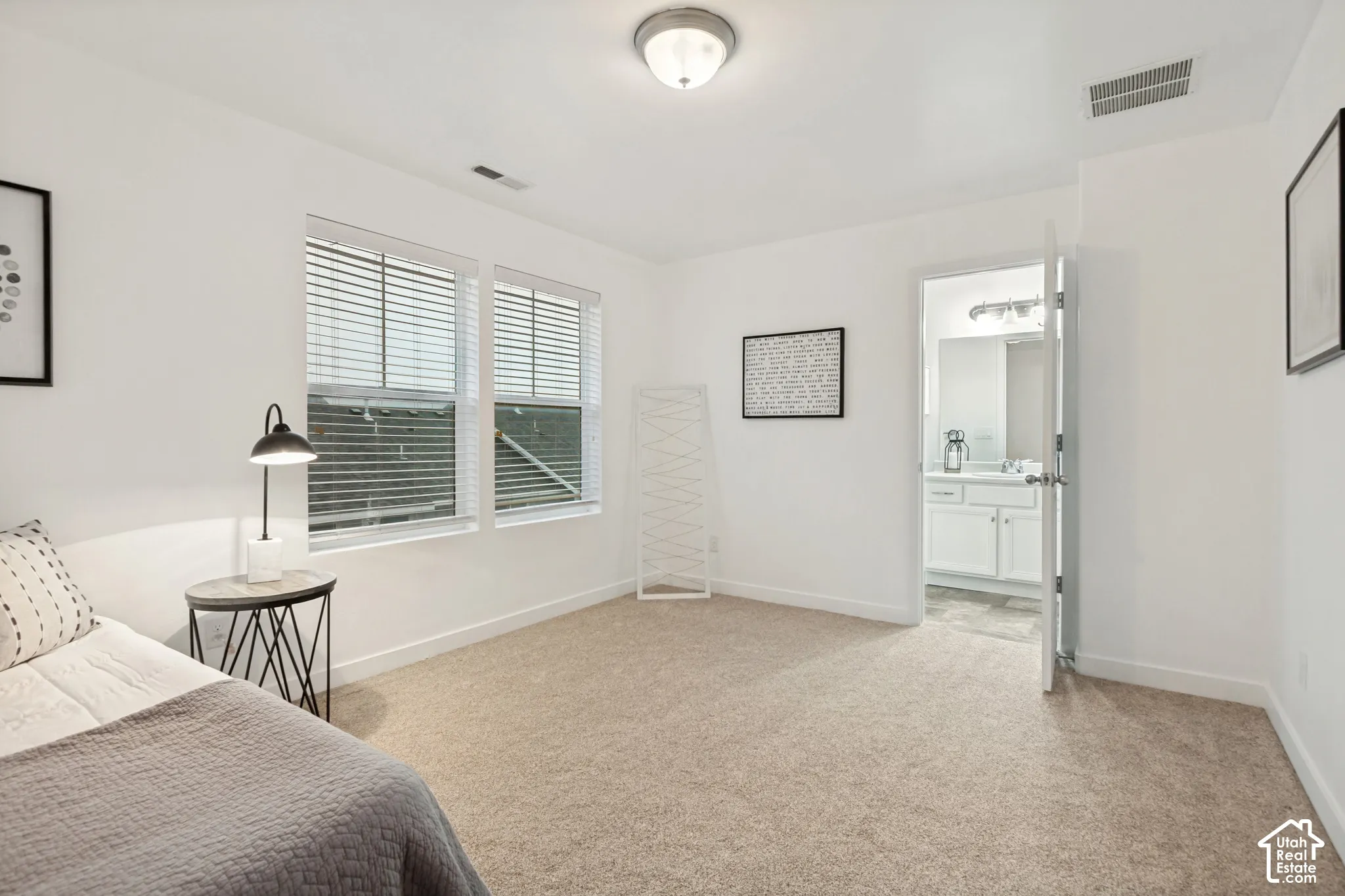 Neutral-toned carpeted flooring, dual-pane windows with integrated blinds, flush-mount lighting, and solid-core interior doors