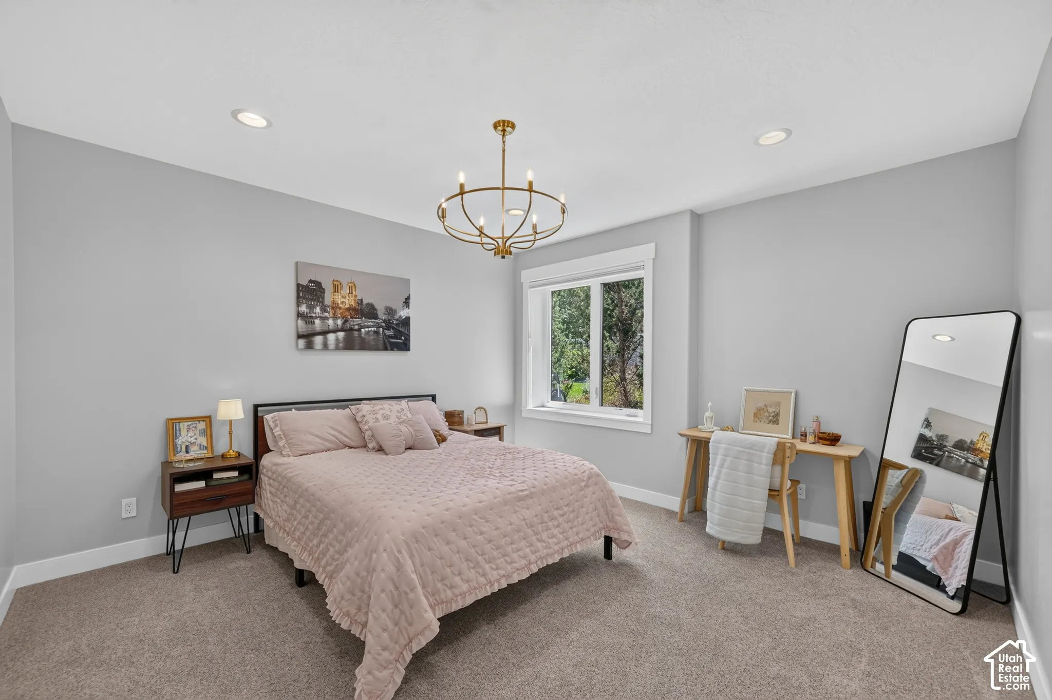 Neutral-toned room featuring recessed lighting, a modern gold-finish chandelier, and a single-pane window