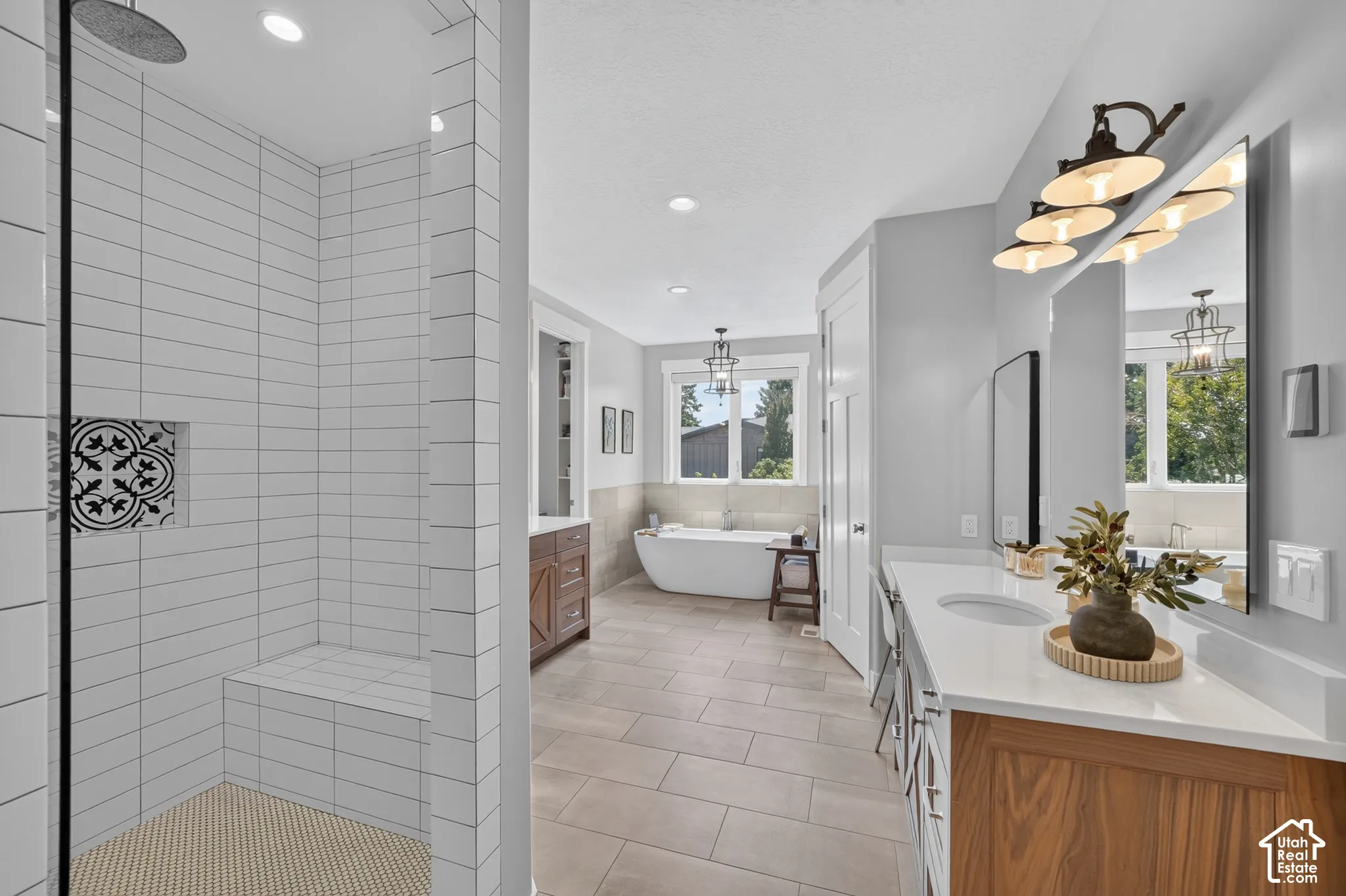 Walk-in shower featuring a built-in tile bench, rain-style shower head, and patterned accent niche