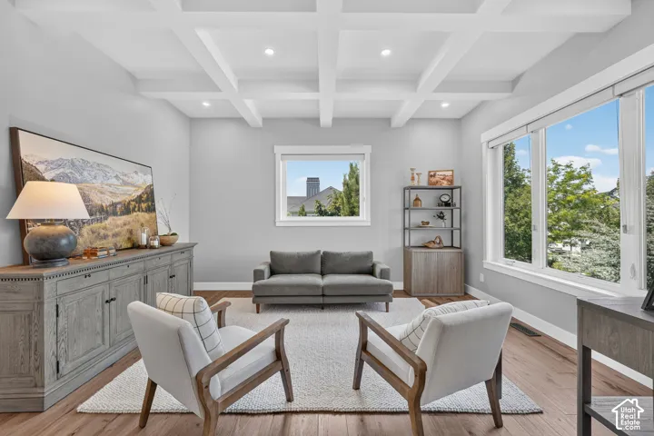 Coffered ceiling with recessed lighting, large windows, and wood-finish flooring