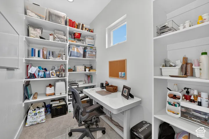 Built-in floor-to-ceiling white shelving and a dedicated window with natural light