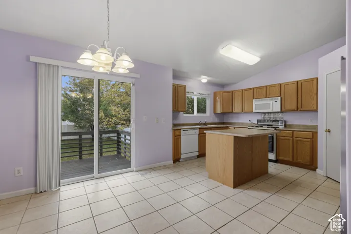 Cozy kitchen with center island, corner pantry and included stainless steel refrigerator