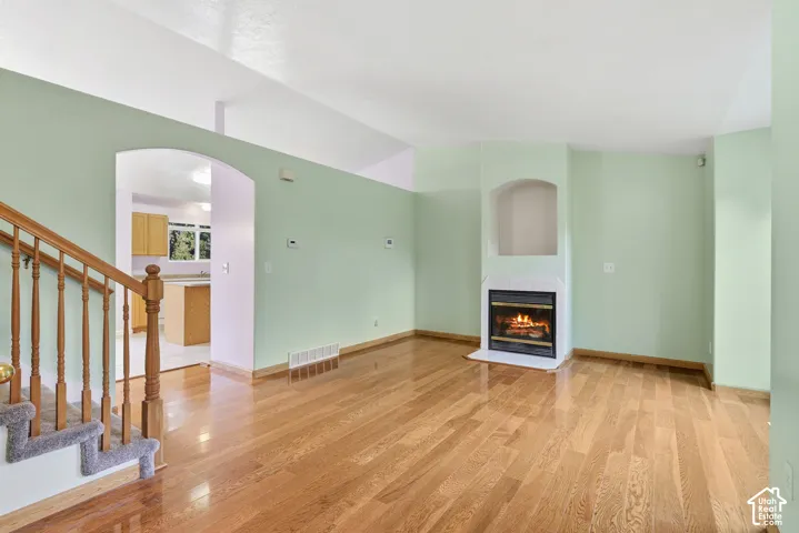 Living room with hardwood floors, cozy gas fireplace and fresh paint