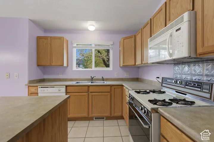 Kitchen with center island, corner pantry and stainless steel refrigerator
