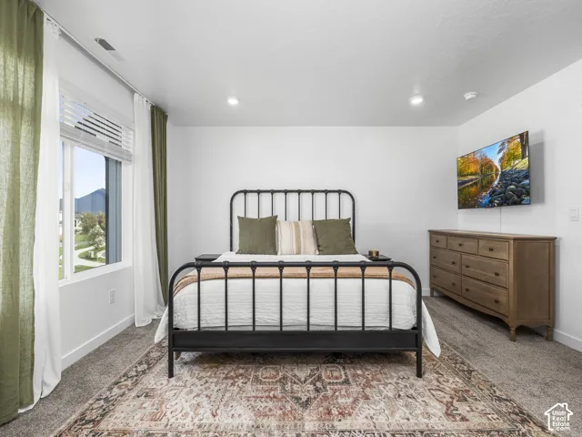 Neutral interior space featuring high ceilings, recessed lighting, wall-to-wall carpeting, and a double-pane window