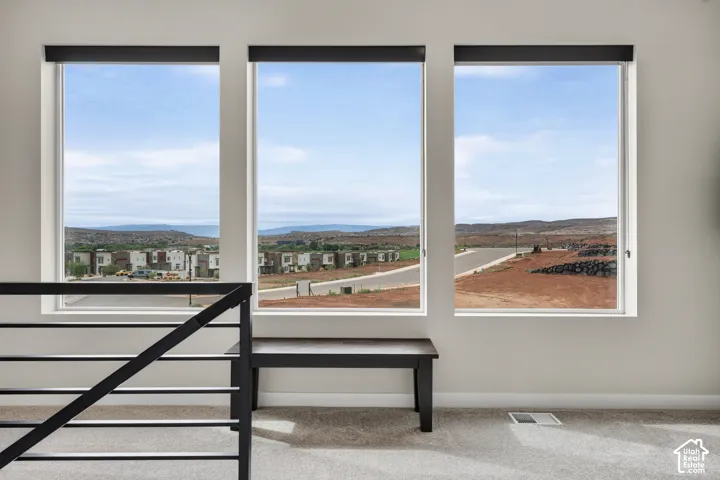 Triple-pane windows with black frames, metal railing, and neutral wall tones