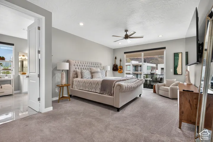 Neutral-toned interior featuring recessed lighting, a modern ceiling fan, wall-to-wall carpeting, and sliding glass doors