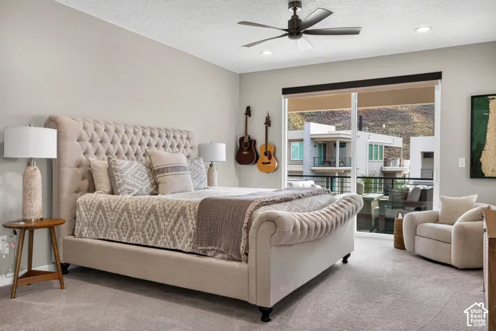 Room featuring neutral wall tones, recessed lighting, matte black ceiling fan, wall-to-wall carpeting, and sliding glass doors