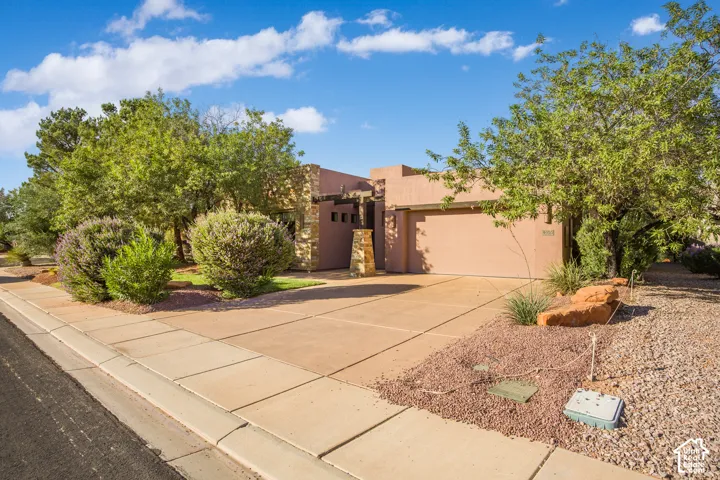 Southwestern adobe-style residence featuring a warm terracotta exterior with stepped architectural detailing