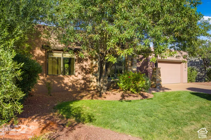 Mature shade trees frame this inviting residence, offering natural cooling and established landscaping