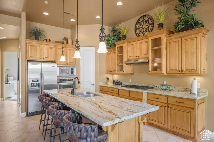 Kitchen featuring light wood cabinetry, granite countertops, stainless steel appliances, and recessed lighting