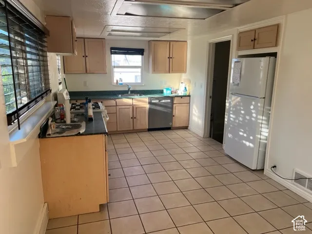 Kitchen featuring light-finish cabinetry, ceramic tile flooring, stainless steel dishwasher, dual-basin sink, and recessed lighting