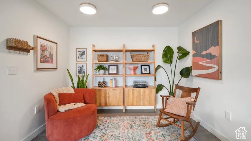 Built-in wood shelving unit with lower cabinet storage and dual flush-mount ceiling light fixtures