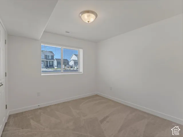 Bedroom #4 with neutral carpeting, window with horizontal blinds, and flush mount lighting