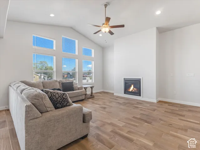 Vaulted ceilings, wood-finish tile flooring, recessed lighting, multi-pane windows, and a built-in fireplace