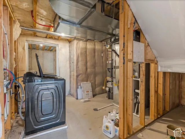 Utility area featuring concrete flooring and secondary laundry hookups