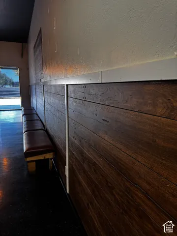 Horizontal wood-plank wall wainscoting with clean-lined trim and dark-toned flooring